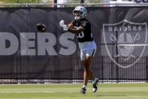 Raiders safety Isaiah Pola-Mao (20) pitches a football back to his teammates during an NFL foot ...
