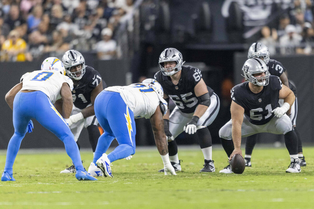 Raiders offensive linemen, from left, DJ Glaze, Alex Cappa and Jordan Meredith line up against ...