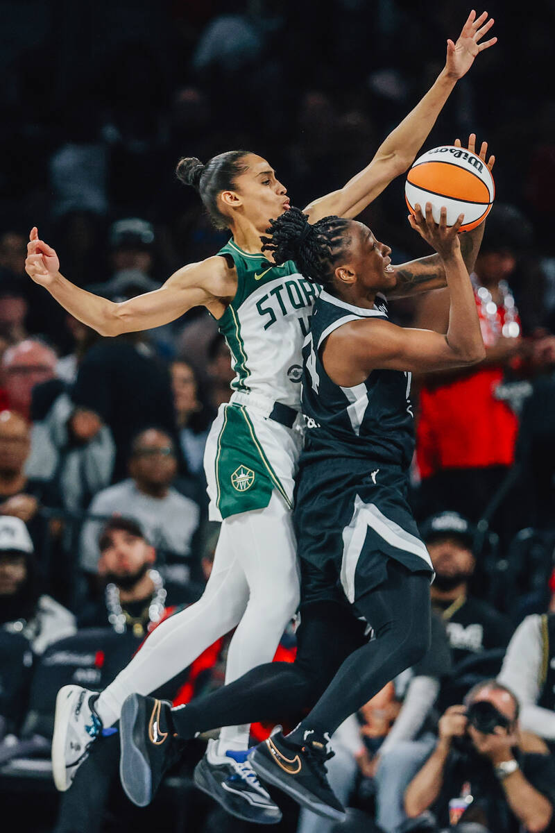 Aces guard Jewell Loyd (24) puts up a shot as Seattle Storm guard Skylar Diggins (4) guards her ...