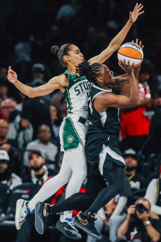 Aces guard Jewell Loyd (24) puts up a shot as Seattle Storm guard Skylar Diggins (4) guards her ...