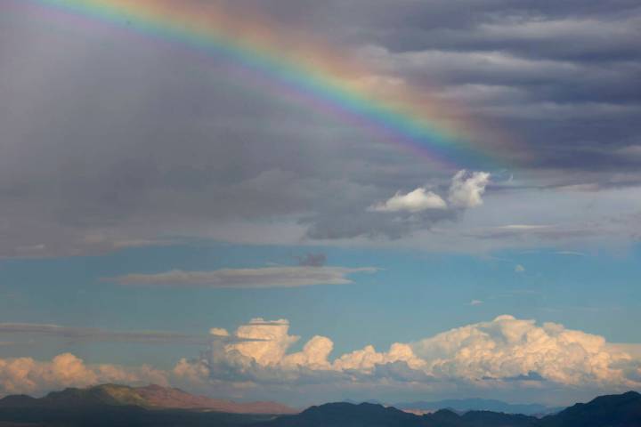 A rainbow stretches across the sky as clouds linger over the Las Vegas Valley as seen from Summ ...