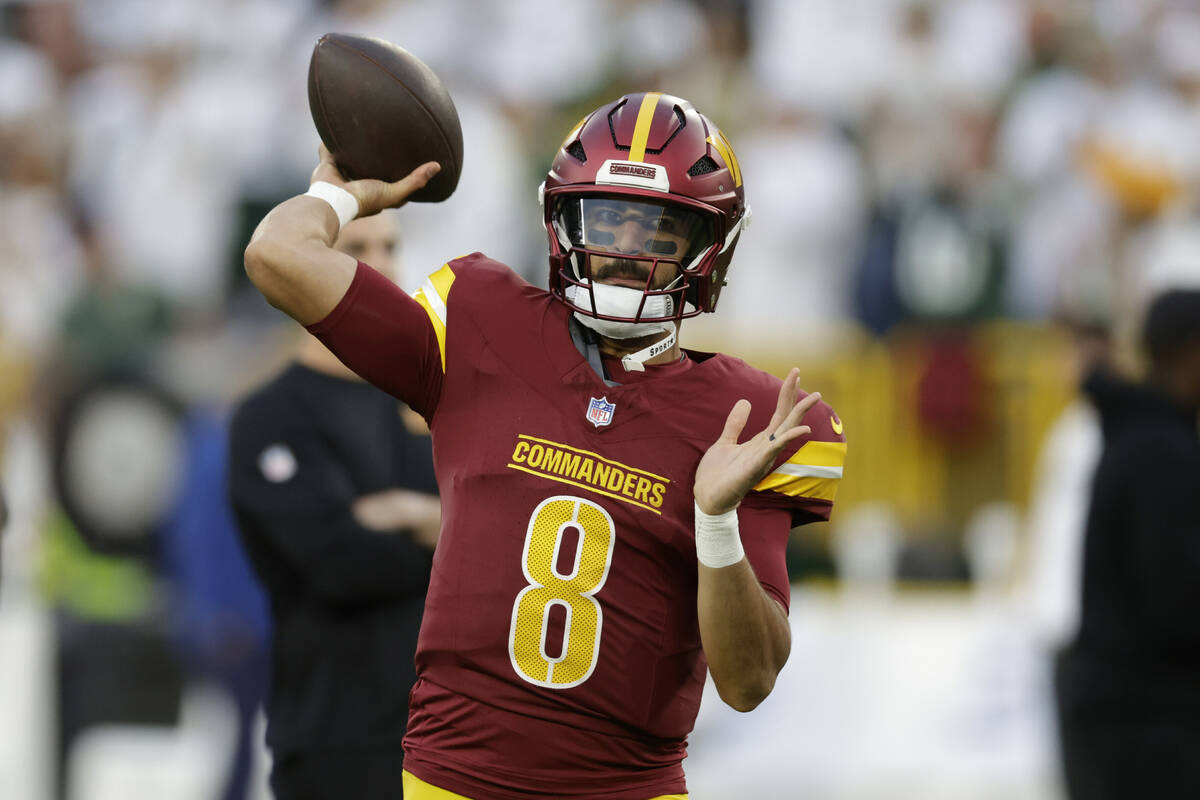 Washington Commanders quarterback Marcus Mariota warms up before an NFL football game against t ...