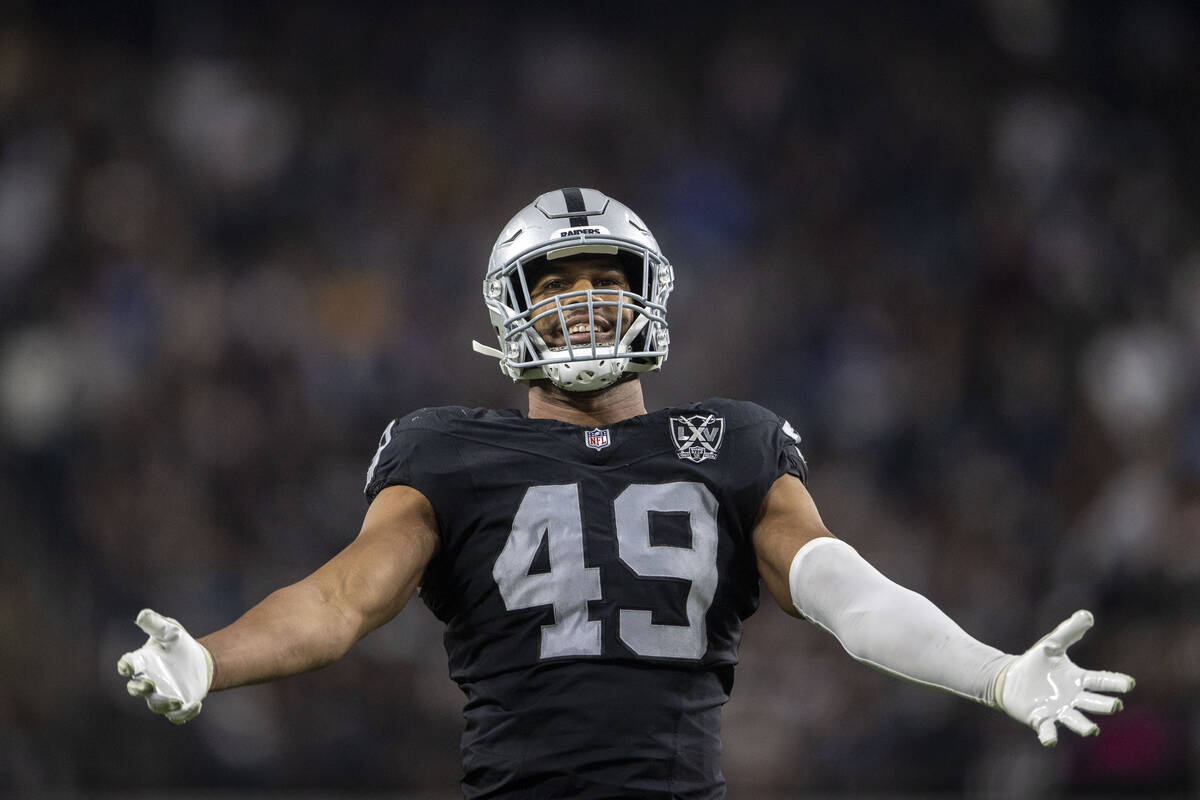 Raiders defensive end Charles Snowden (49) amps up the crowd during the second half of an NFL g ...