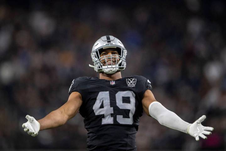 Raiders defensive end Charles Snowden (49) amps up the crowd during the second half of an NFL g ...