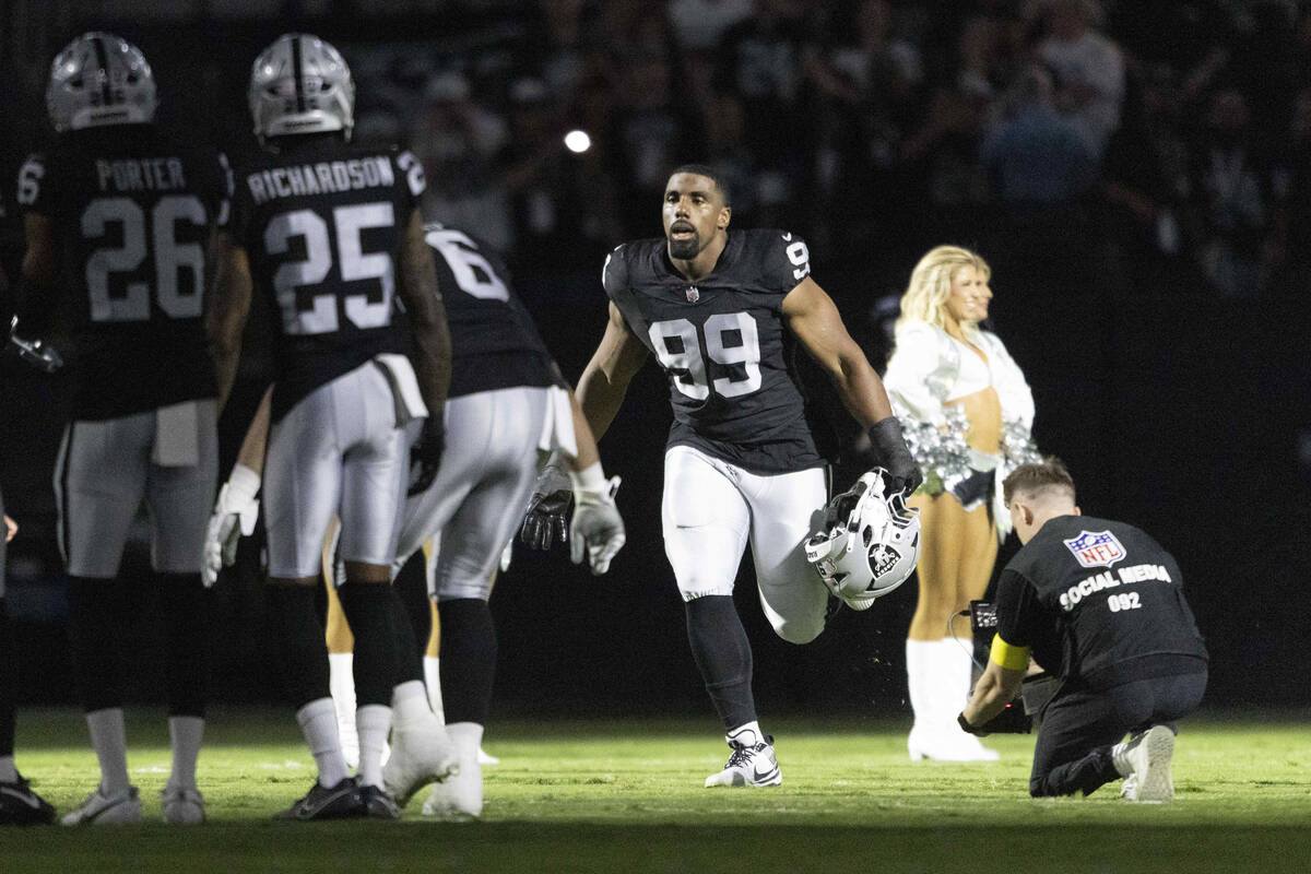 Raiders defensive tackle Thomas Booker (99) runs on the field as he’s introduced before ...
