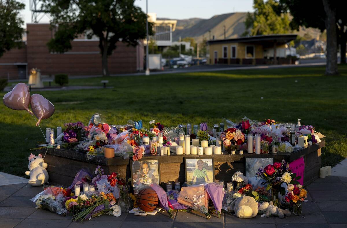 Pictures, flowers and candles mark a makeshift memorial, June 3, 2025, in Wenatchee, Wash., in ...