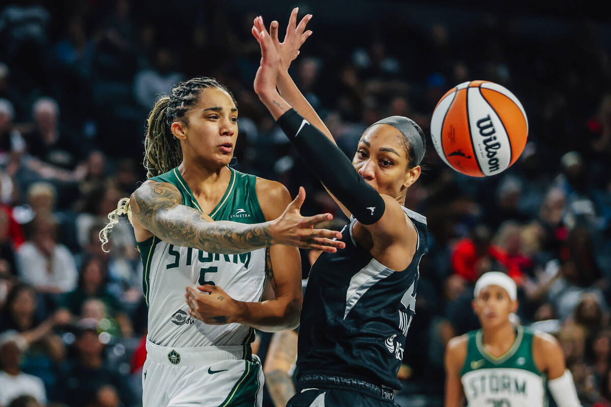 Aces center A'ja Wilson (22) guards Seattle Storm forward Gabby Williams (5) as she passes ...