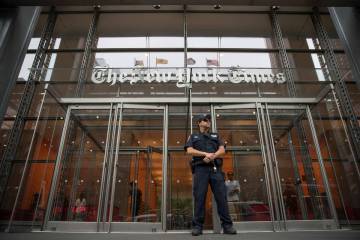 FILE- A police officer stands guard outside The New York Times building in New York, on June 28 ...