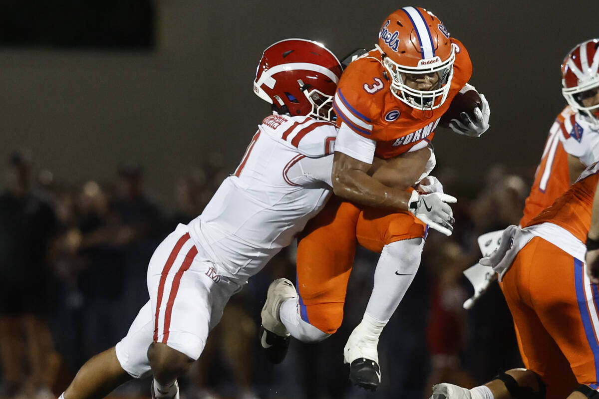 Bishop Gorman running back Terrance Grant (3) is tackled by Mater Dei linebacker Shaun Scott (0 ...