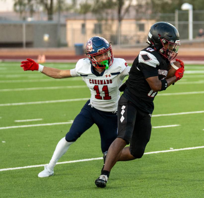 Desert Oasis’s Giovanni Corso (28) is taken down by Coronado’s Landon Sanford (11 ...