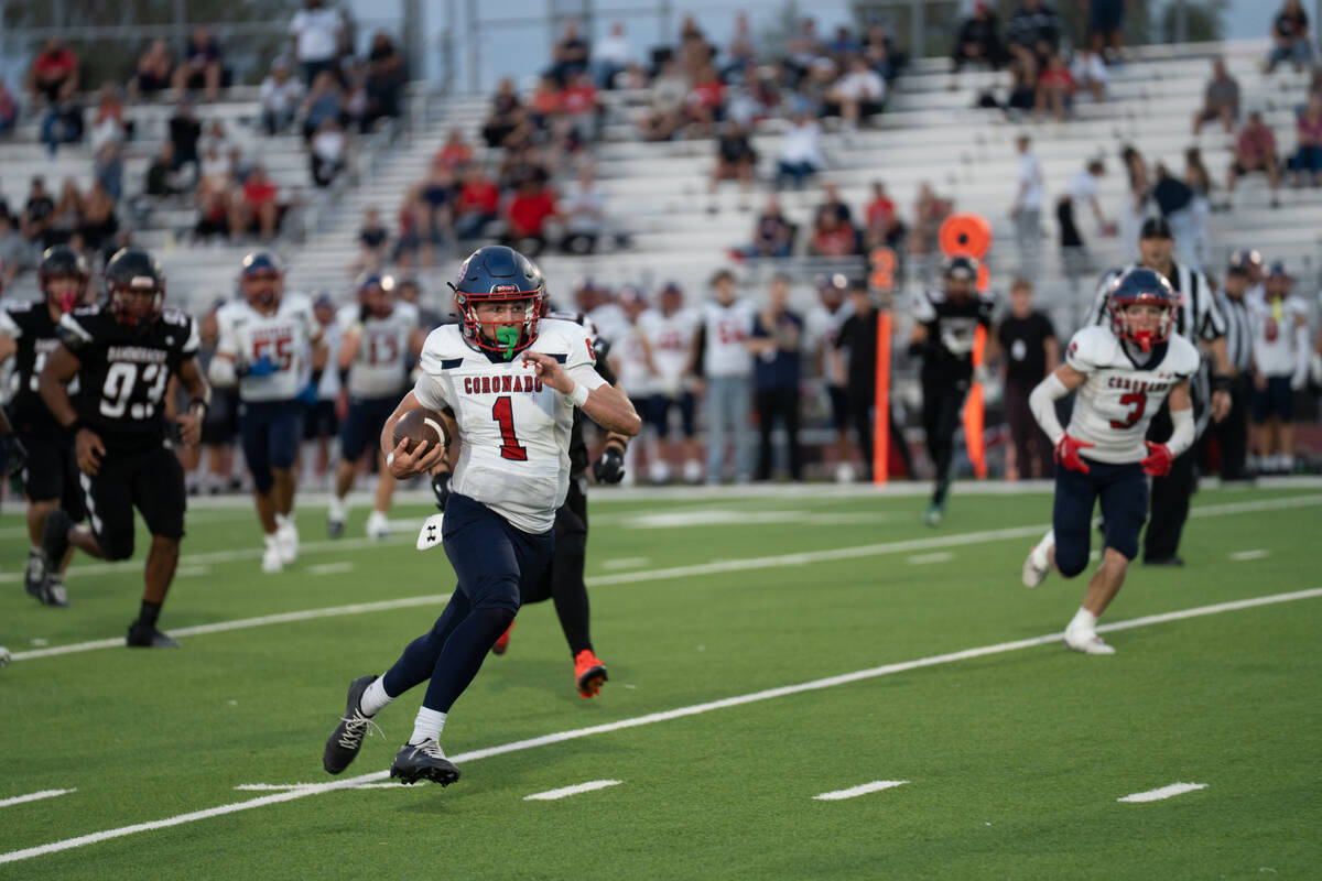 Coronado’s quarterback Jackson Humphries (1) makes his way down the field during a footb ...