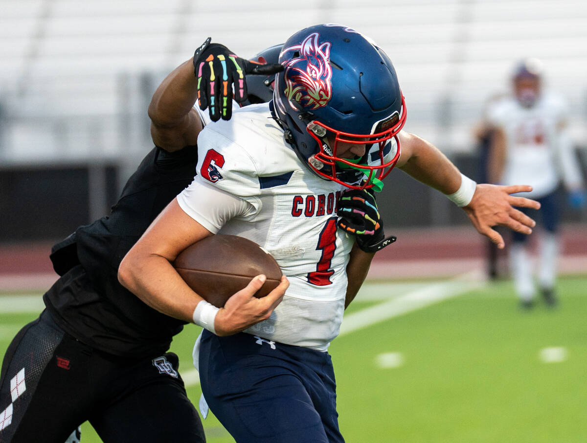Coronado’s quarterback Jackson Humphries (1) holds back Desert Oasis’s Eric Johns ...