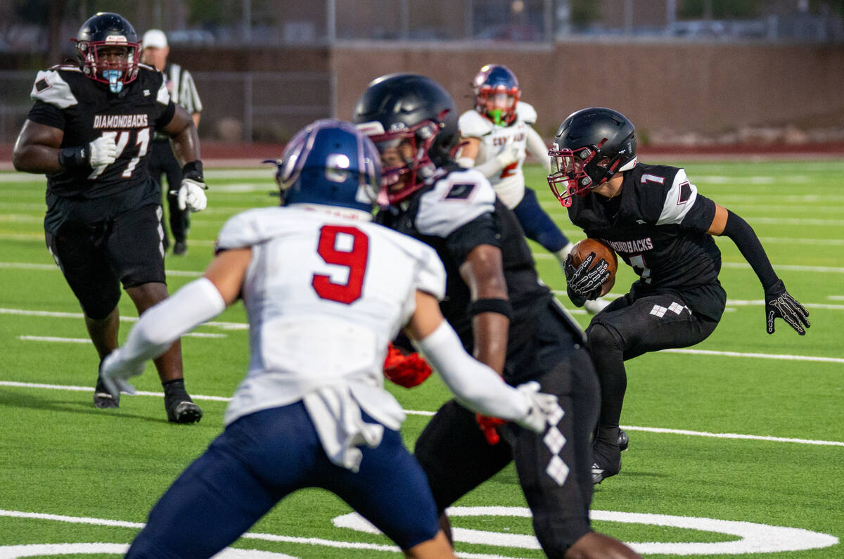 Desert Oasis searches for an open path through defenders during a football game against Coronad ...