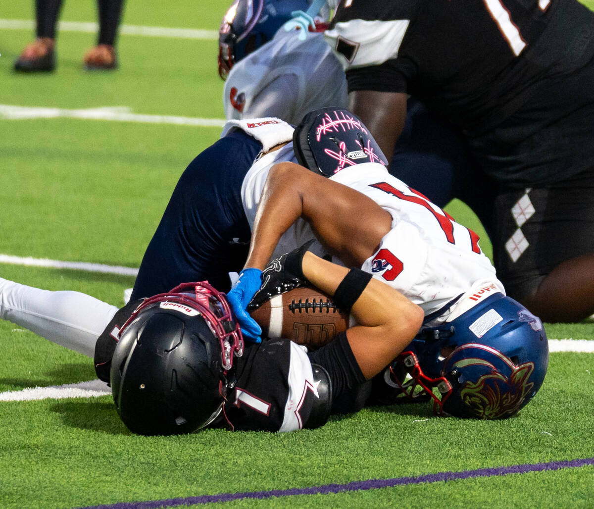 Desert Oasis and Coronado wrestle for the ball during a football game against Coronado at Deser ...