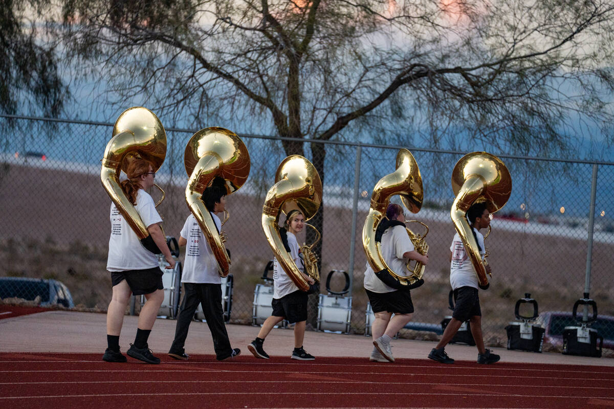The Desert Oasis marching band warms up for their half time performance during a football game ...