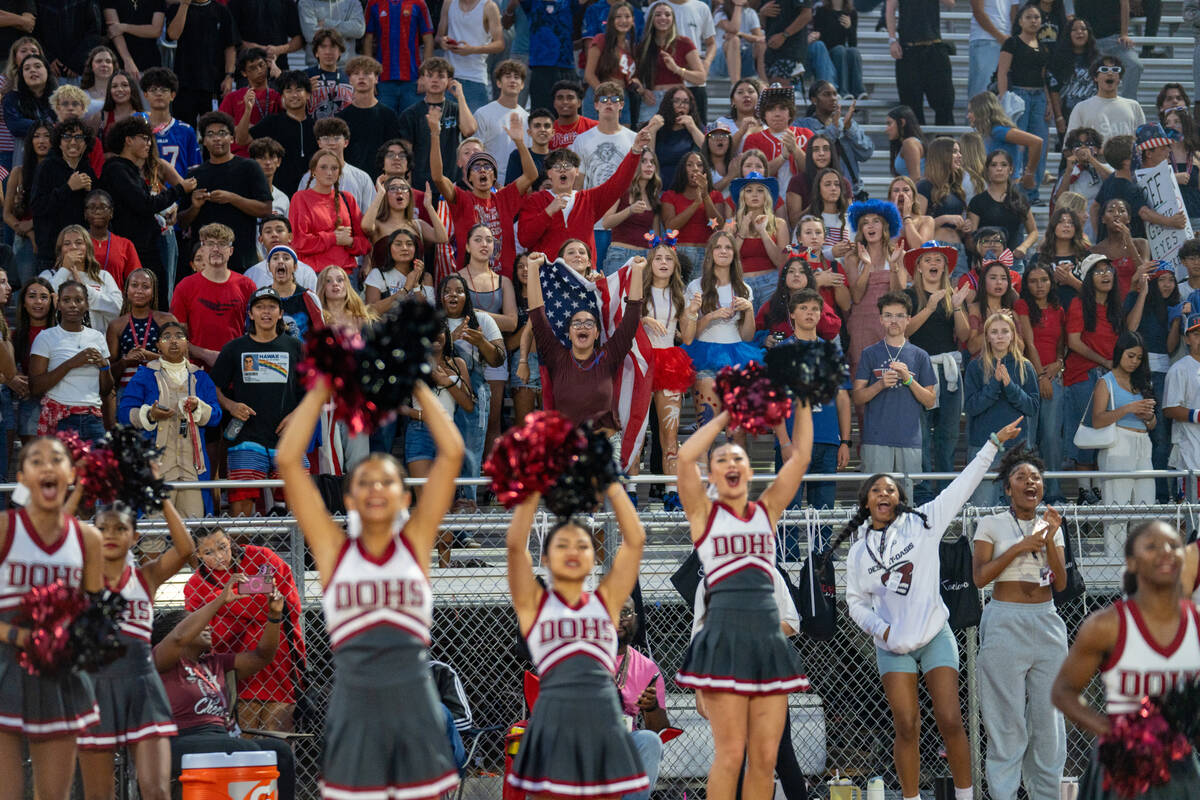 Desert Oasis cheerleader and the home student section dressed in red, white, and blue react to ...