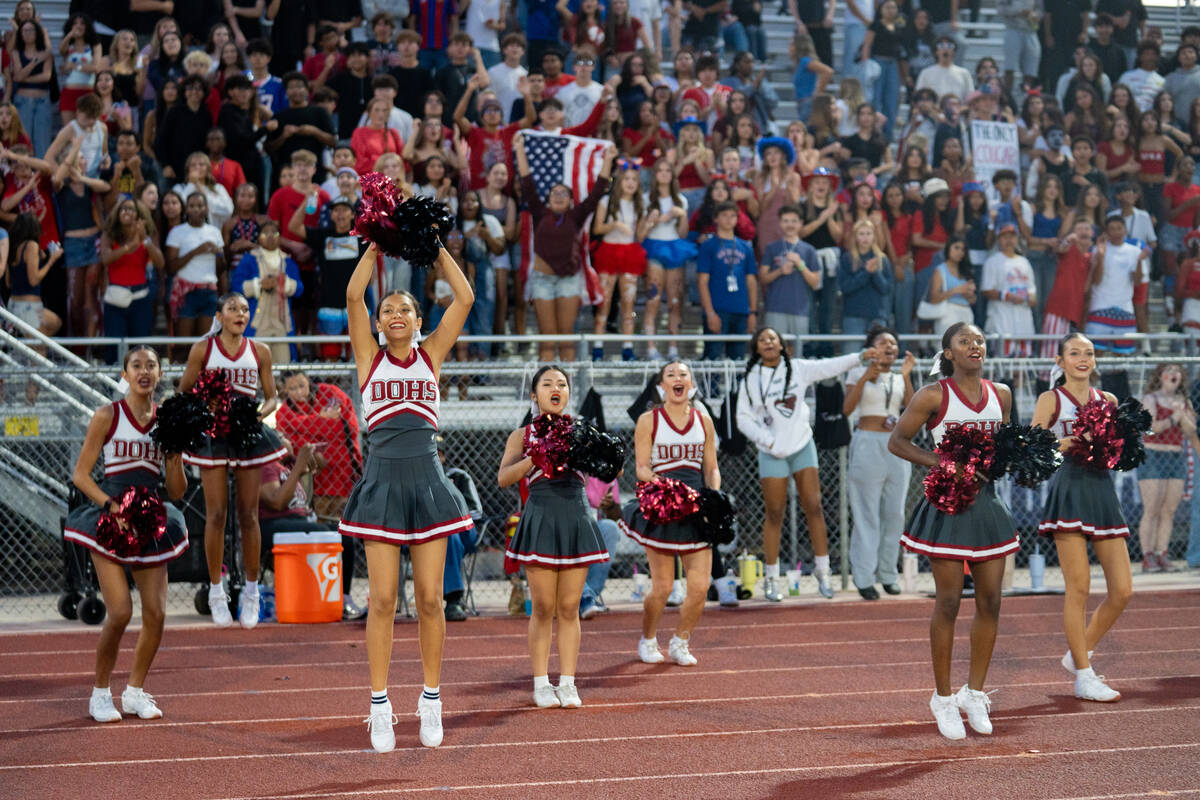 Desert Oasis cheerleader and the home student section dressed in red, white, and blue react to ...