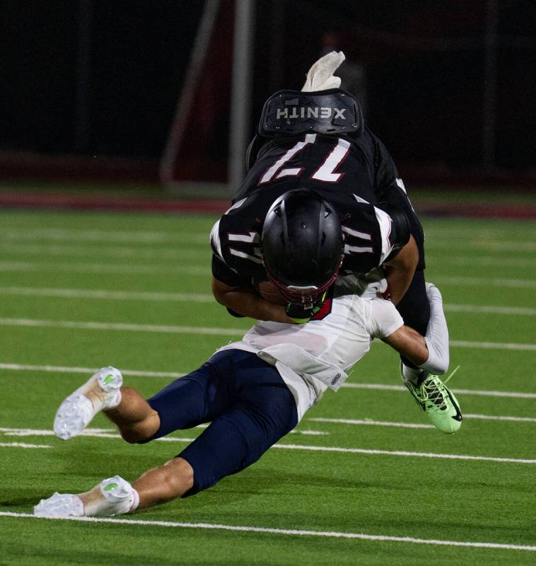Desert Oasis Andrew Richmond (17) is taken down by Coronado’s Nick Battisti (13) during ...