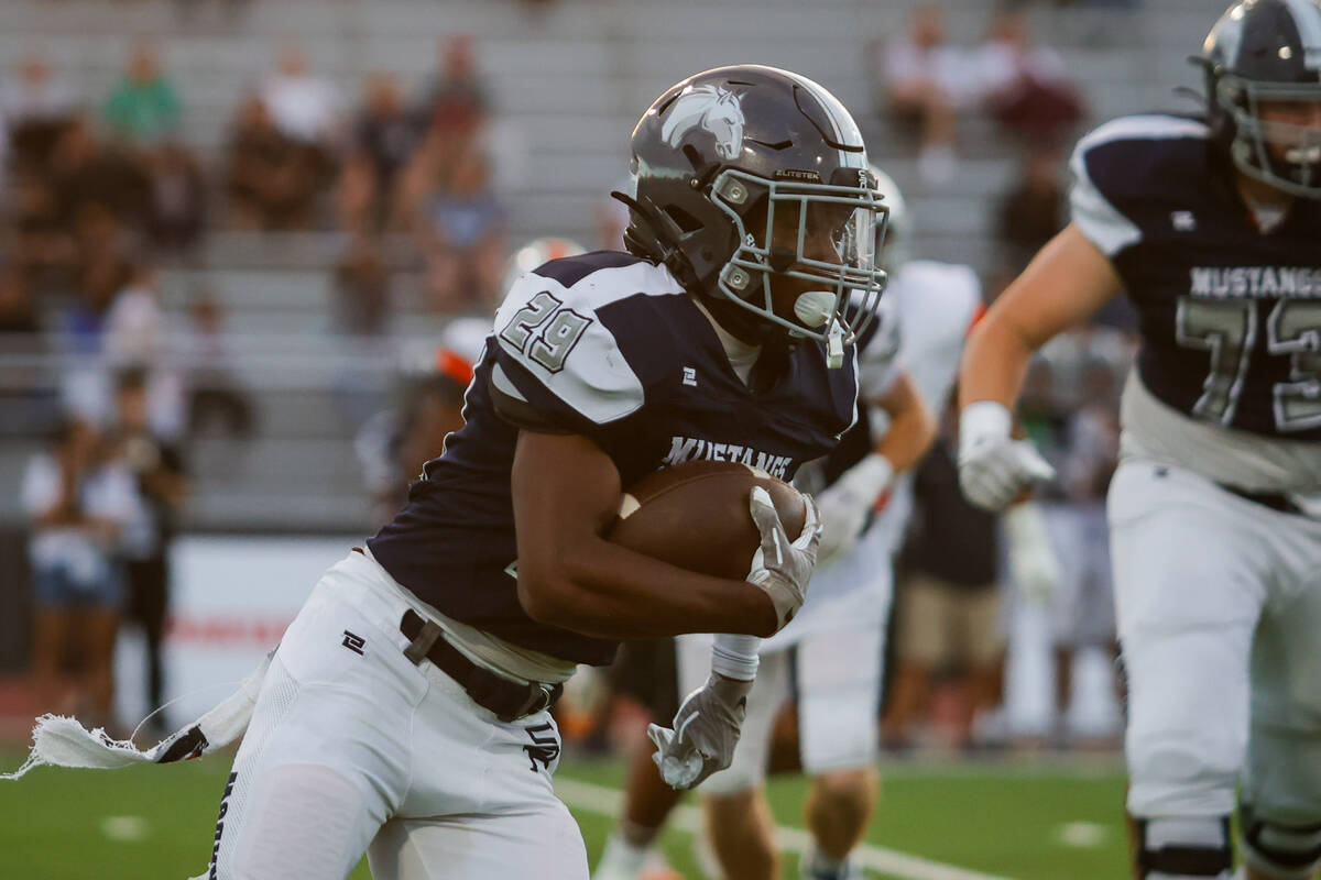Shadow Ridge Trevin Young (29) runs the ball during an NIAA Football game between Shadow Ridge ...