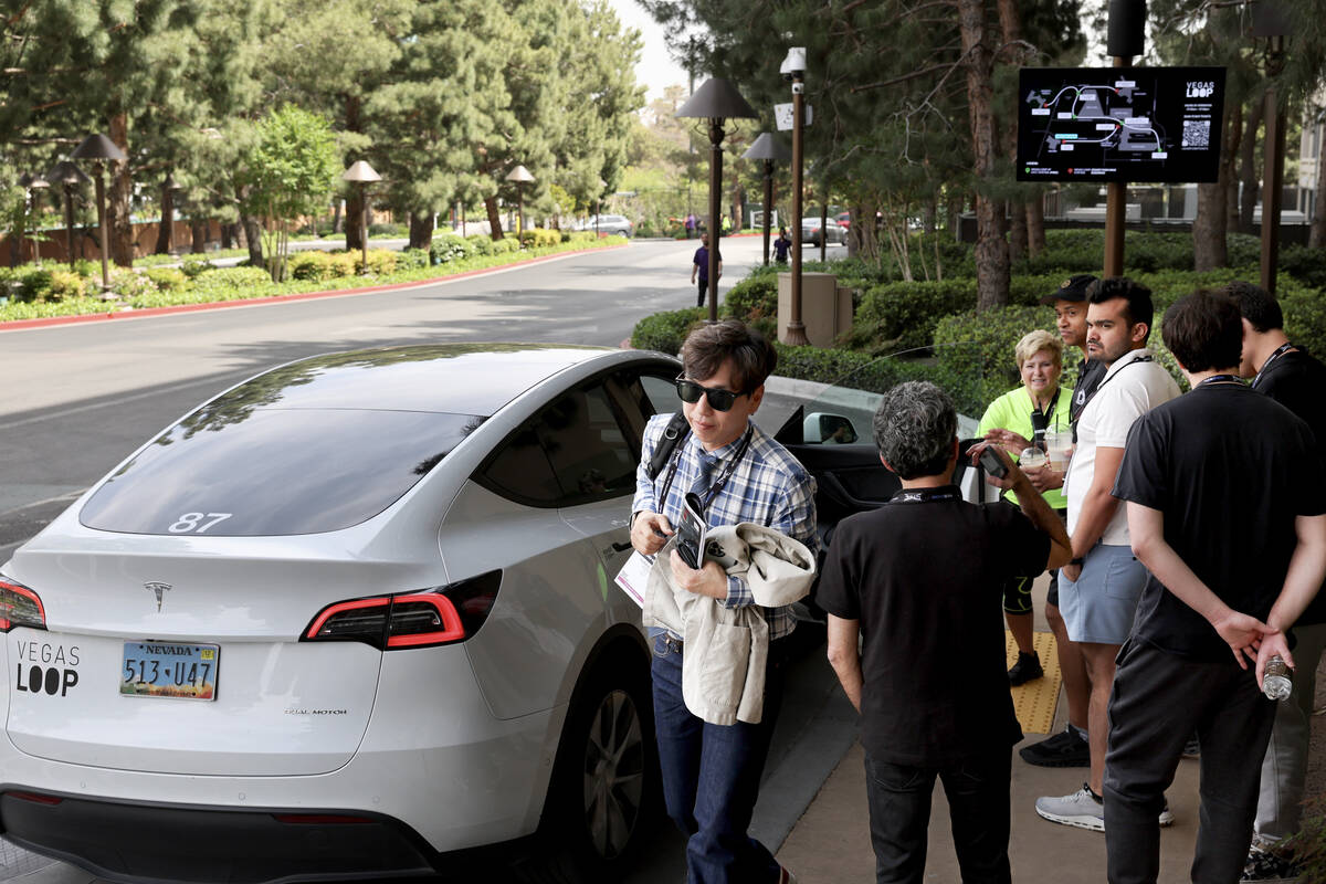 Riders come and go from vehicles at the new Vegas Loop Encore station in Las Vegas Tuesday, Apr ...
