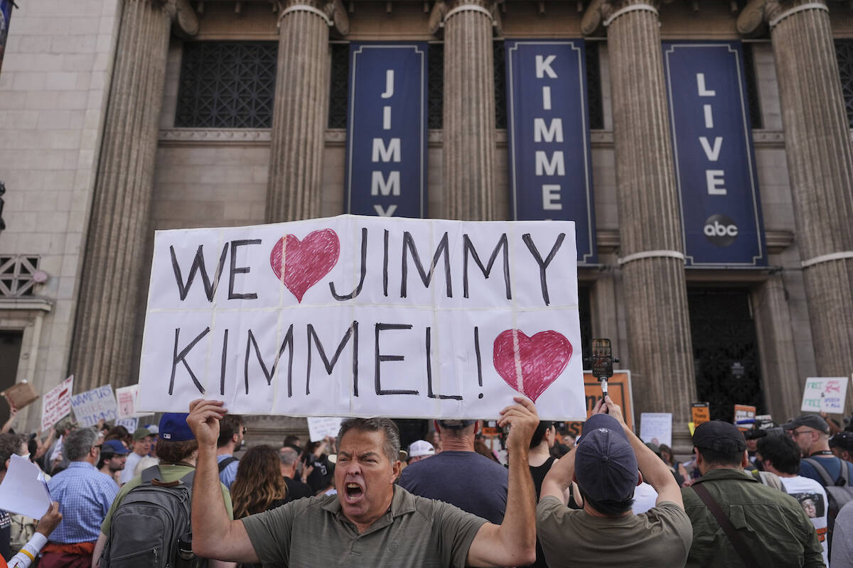 Oscar Villanueva holds a sign outside El Capitan Entertainment Centre, where the late-night sho ...