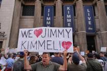 Oscar Villanueva holds a sign outside El Capitan Entertainment Centre, where the late-night sho ...