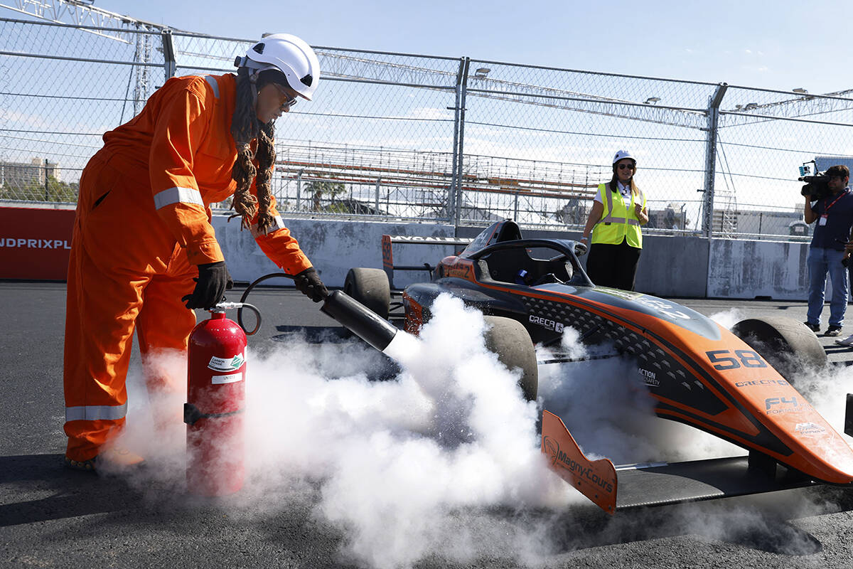Tanya Moore, an intervention marshal, demonstrates how a CO2 fire extinguisher is used on a rac ...