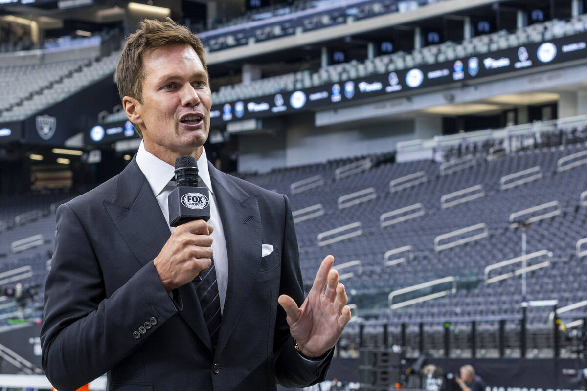 Raiders minority owner and Fox football analyst Tom Brady talks at Allegiant Stadium on Monday, ...