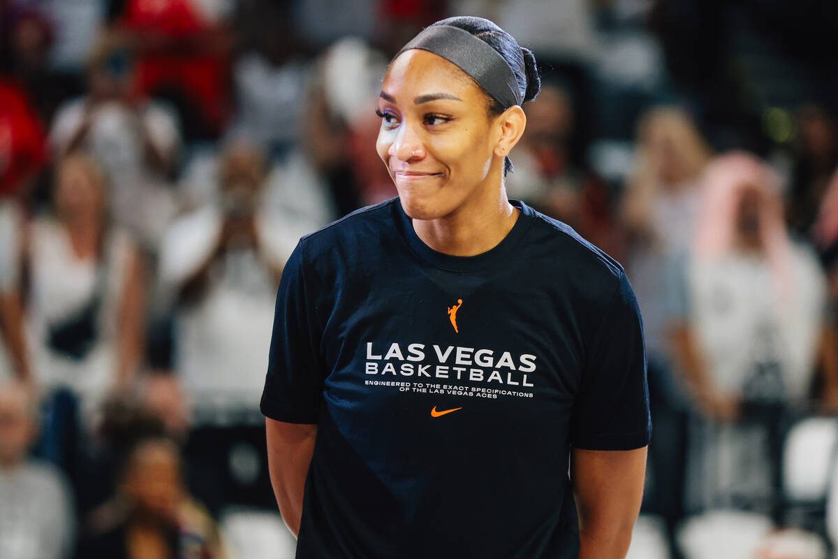 Aces center A'ja Wilson accepts her MVP trophy before game one of a round two WNBA playoff ...