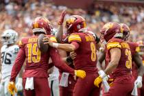 Washington Commanders quarterback Marcus Mariota (8) celebrates his touchdown with wide receive ...