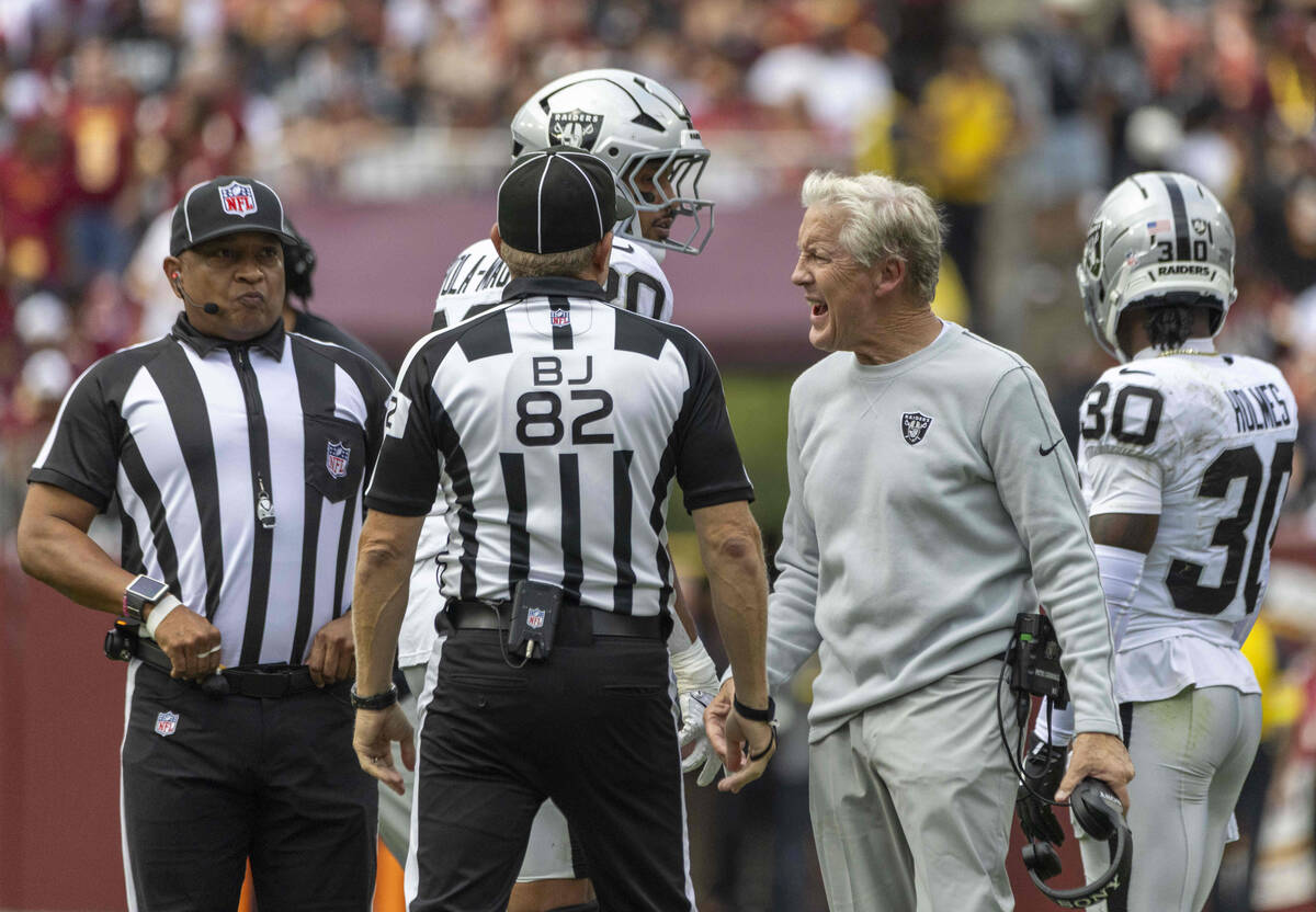 Raiders head coach Pete Carroll shouts as back judge Jimmy Russell (82) and down judge Patrick ...