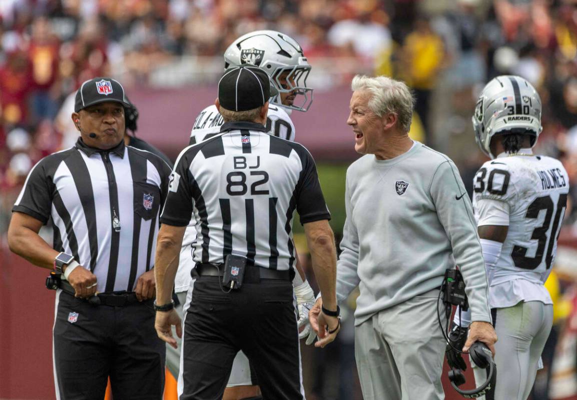 Raiders head coach Pete Carroll shouts as back judge Jimmy Russell (82) and down judge Patrick ...