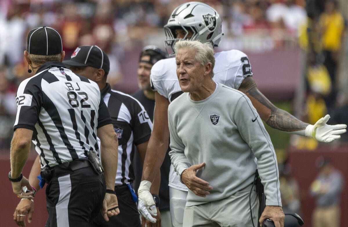 Raiders head coach Pete Carroll shouts as back judge Jimmy Russell (82) and down judge Patrick ...