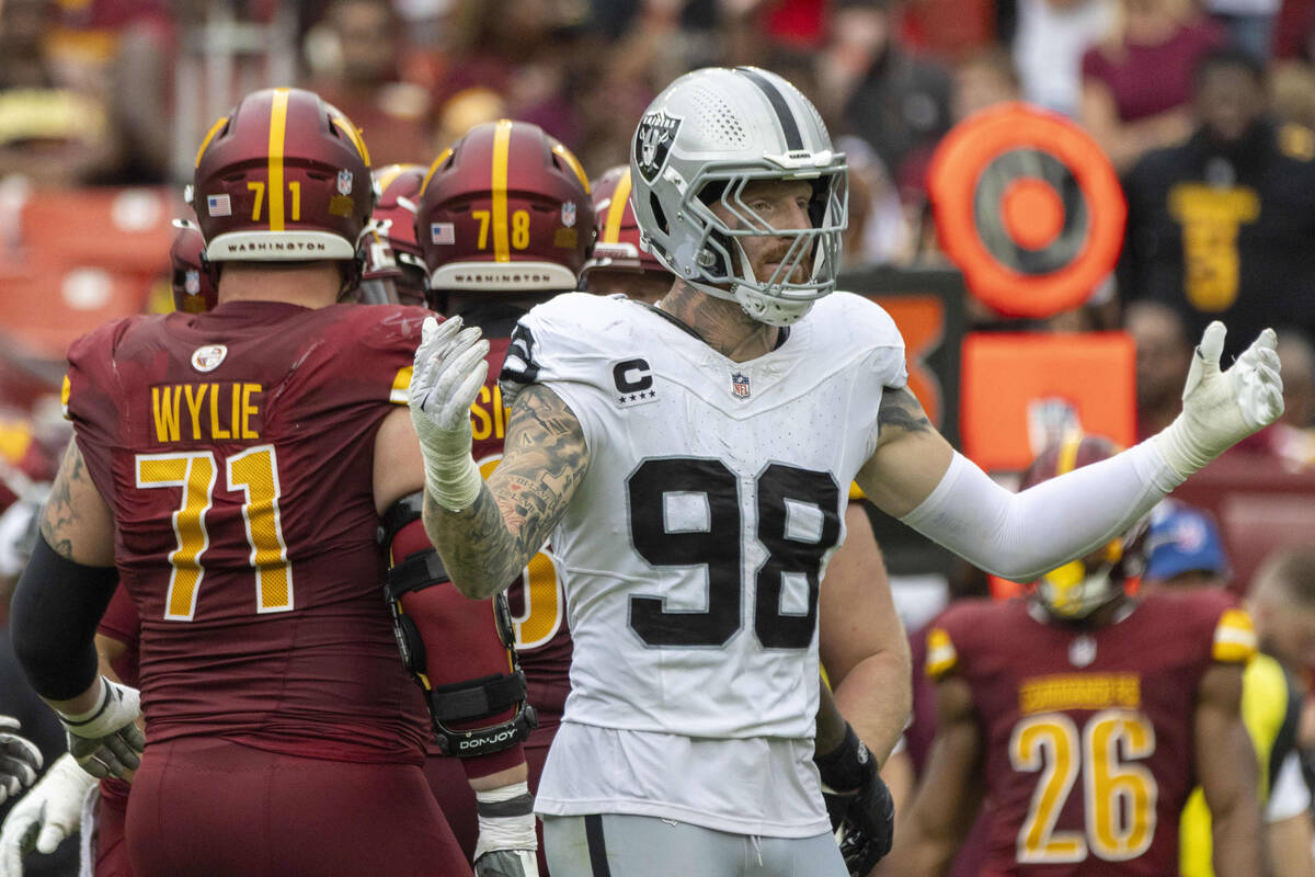 Raiders defensive end Maxx Crosby (98) reacts to a flag thrown against the team with Washington ...