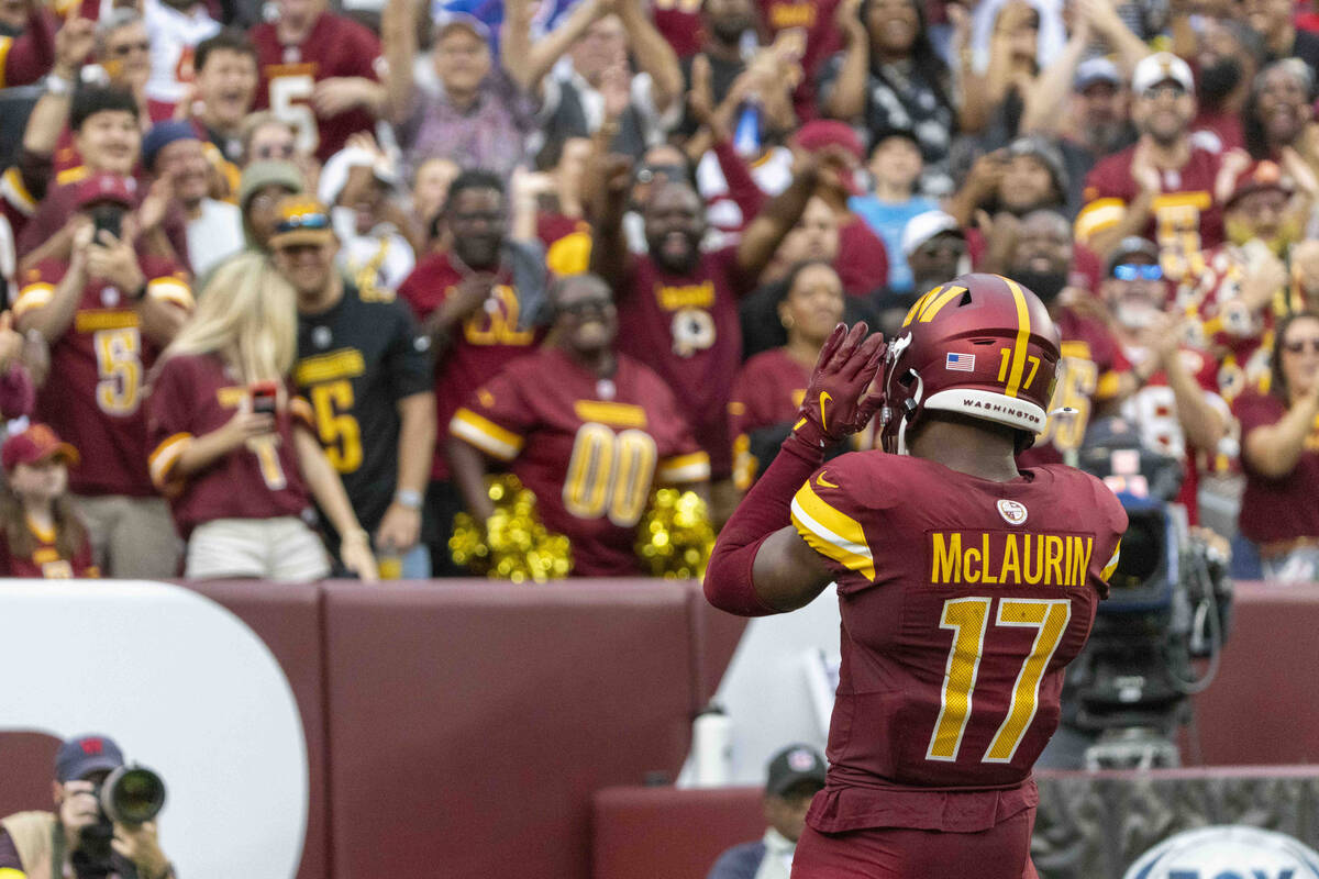 Washington Commanders wide receiver Terry McLaurin (17) gestures towards the crowd cheering for ...