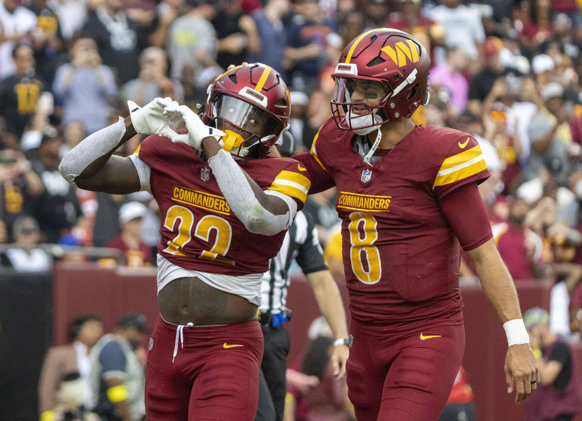 Washington Commanders running back Jacory Croskey-Merritt (22) celebrates his touchdown with qu ...