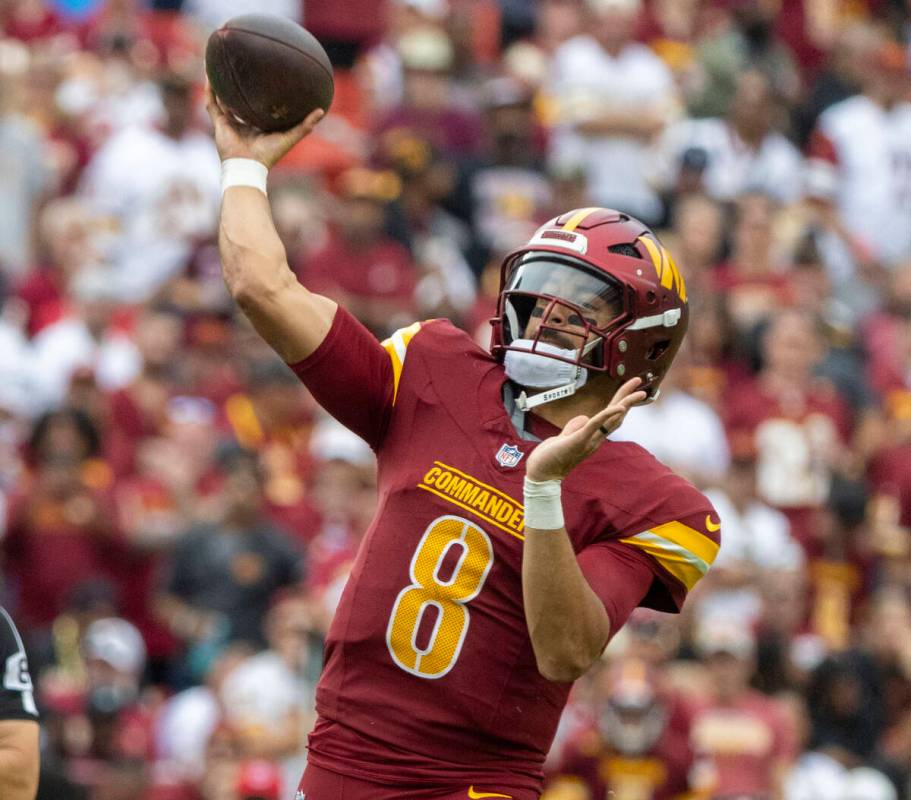 Washington Commanders quarterback Marcus Mariota (8) makes a throw against the Raiders during t ...