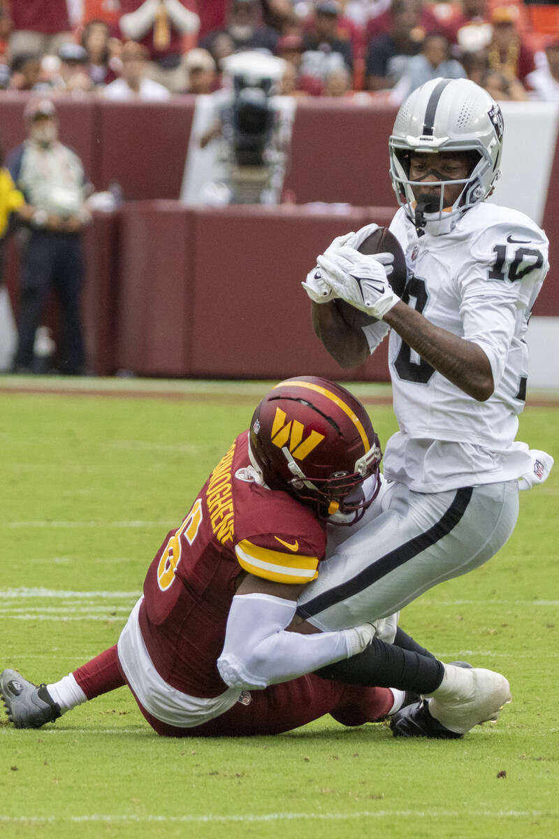 Raiders wide receiver Dont'E Thornton Jr. (10) makes a catch with Washington Commanders co ...