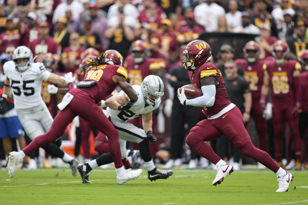 Washington Commanders wide receiver Deebo Samuel (1) runs with the ball during the first half o ...