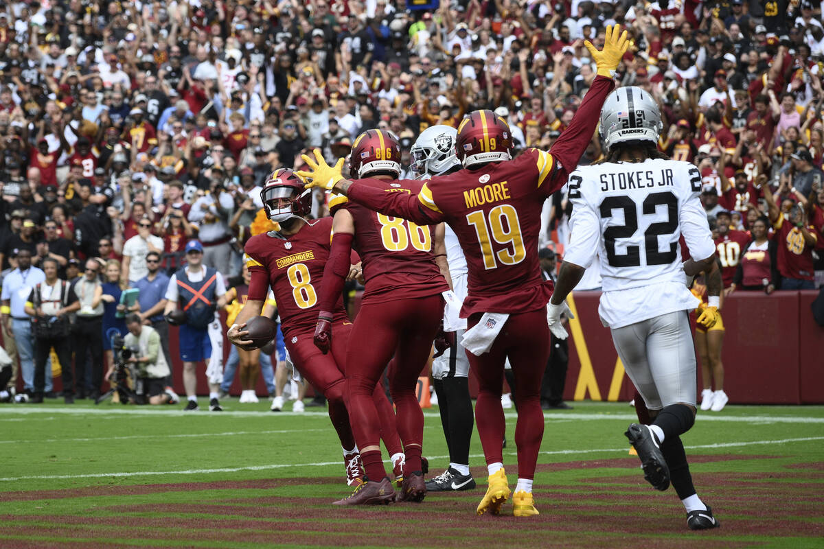 Washington Commanders quarterback Marcus Mariota (8) celebrates after scoring a touchdown durin ...