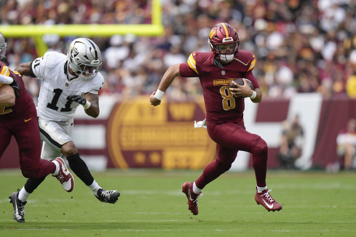 Washington Commanders quarterback Marcus Mariota (8) runs with the ball during the first half o ...