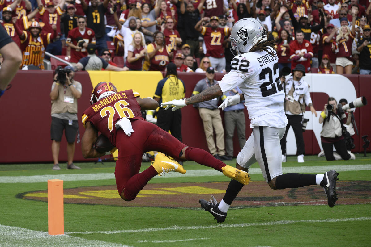 Washington Commanders running back Jeremy McNichols (26) scores a touchdown during the first ha ...
