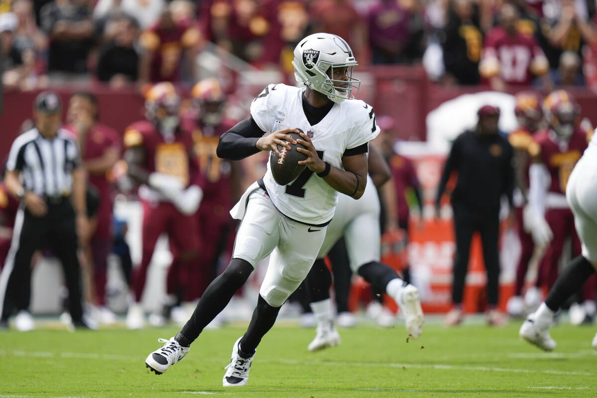 Las Vegas Raiders quarterback Geno Smith (7) looks to throw during the first half of NFL footba ...