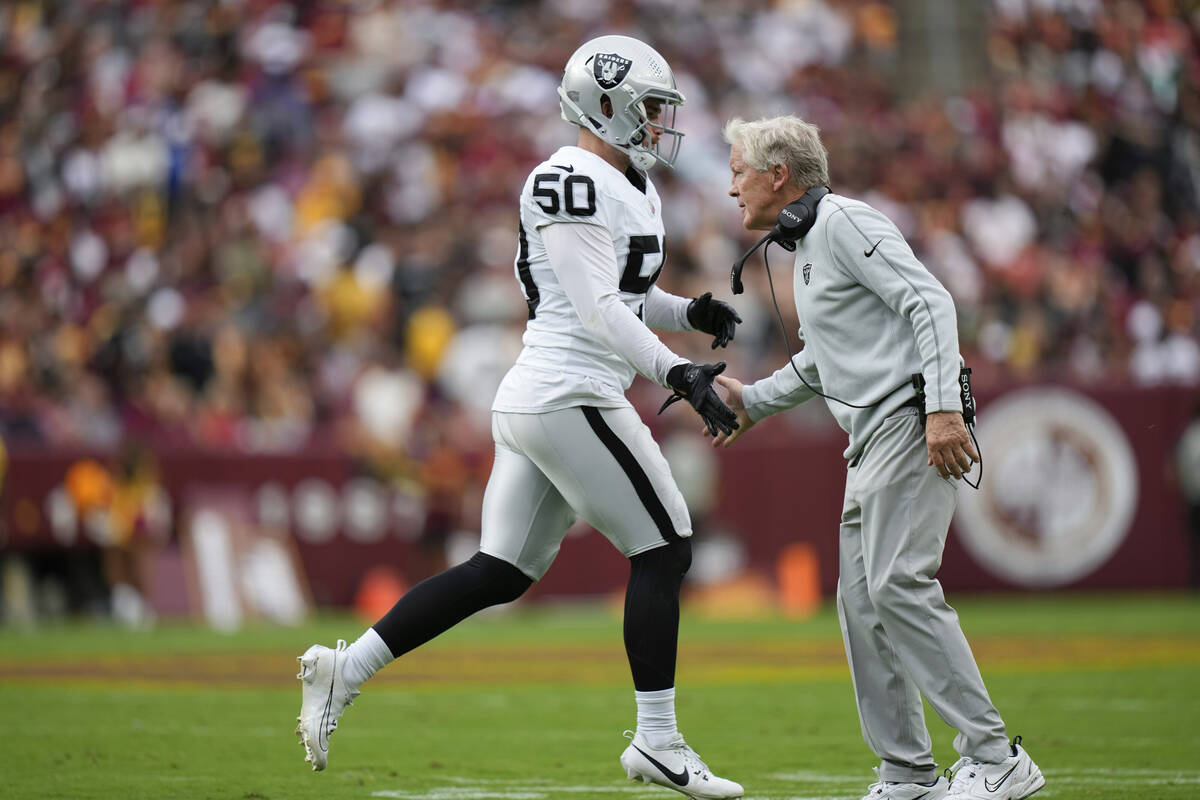 Las Vegas Raiders Pete Carroll shakes hands with long snapper Jacob Bobenmoyer (50) during the ...