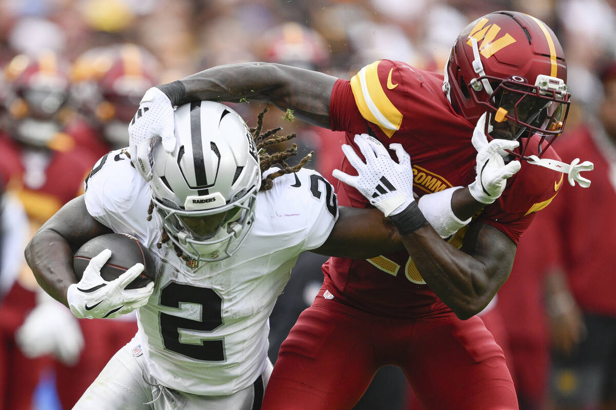 Las Vegas Raiders running back Ashton Jeanty (2) runs against Washington Commanders safety Quan ...