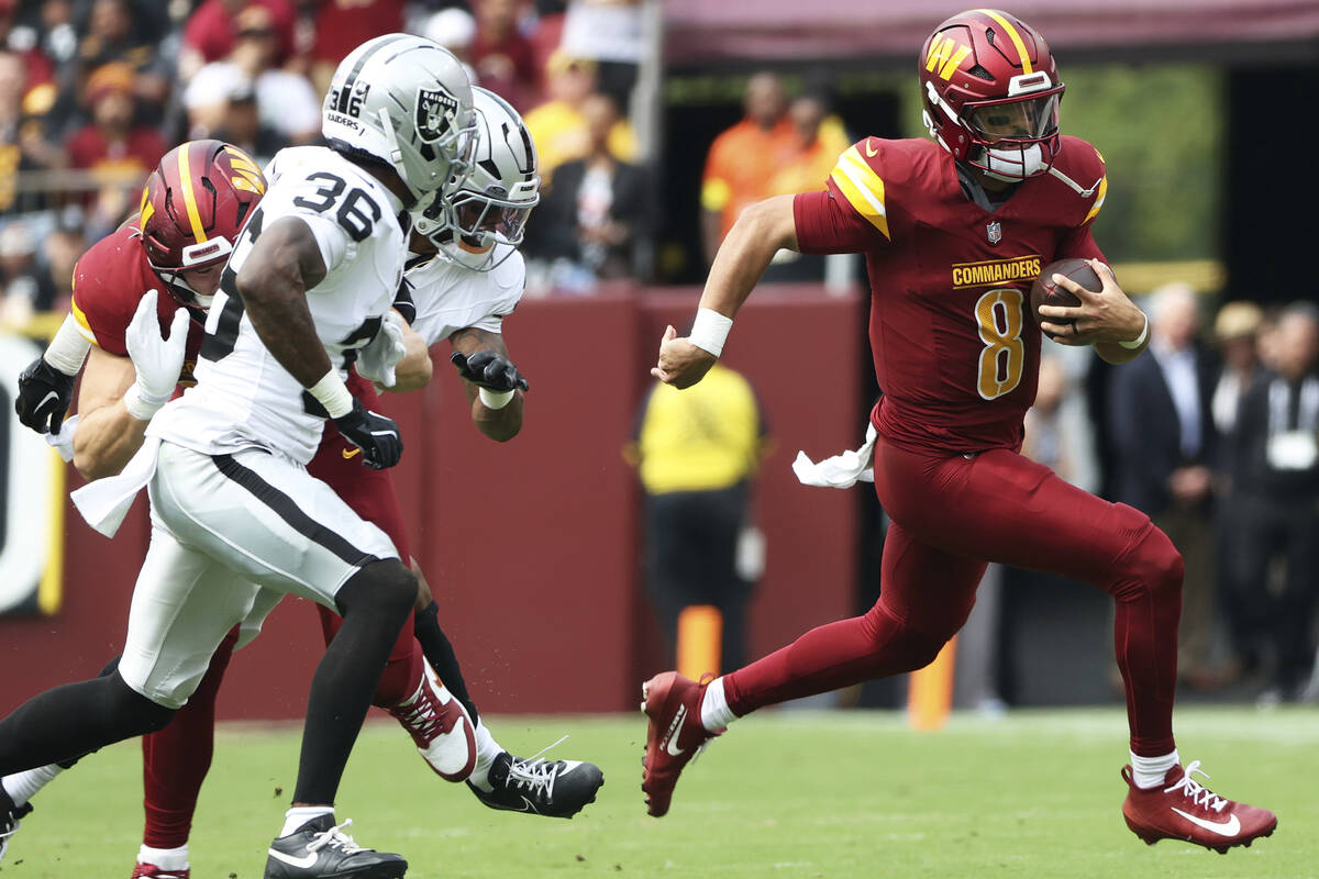 Washington Commanders quarterback Marcus Mariota (8) runs with the ball during an NFL football ...
