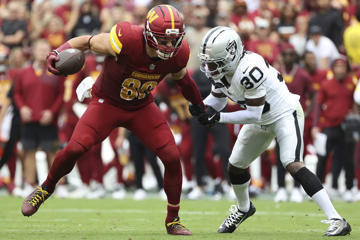 Washington Commanders tight end Zach Ertz (86) runs past Las Vegas Raiders cornerback Darnay Ho ...