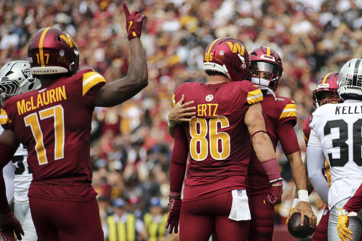 Washington Commanders quarterback Marcus Mariota (8) celebrates with Washington Commanders tigh ...