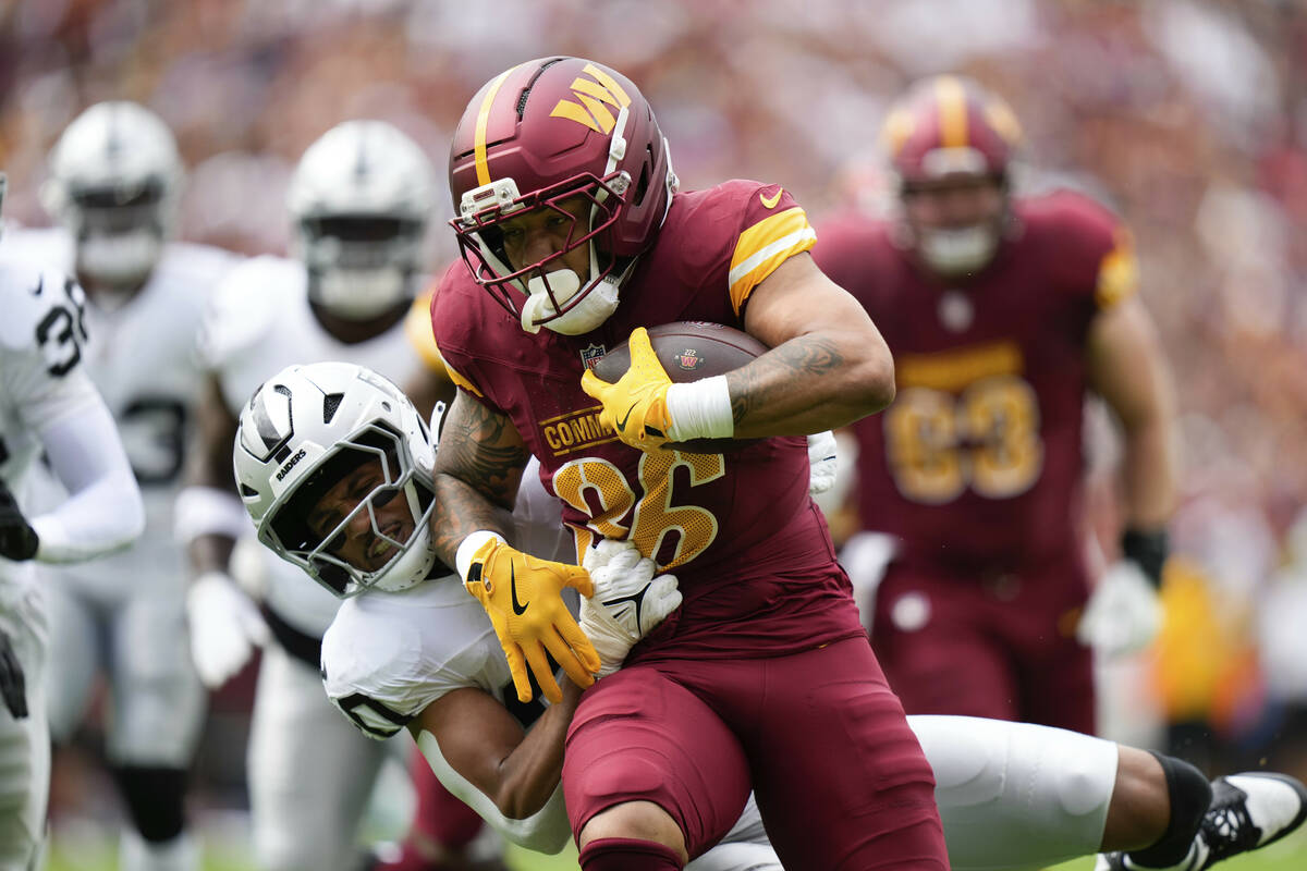 Las Vegas Raiders safety Isaiah Pola-Mao (20) defends as Washington Commanders running back Chr ...