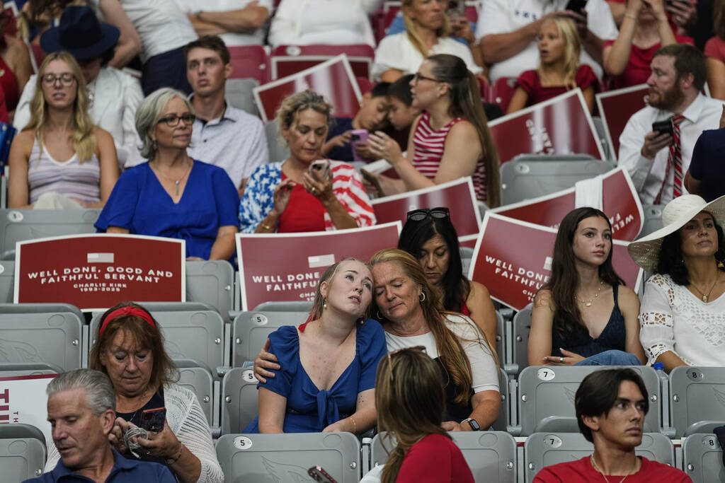 People sit inside before the start of a memorial for conservative activist Charlie Kirk, Sunday ...